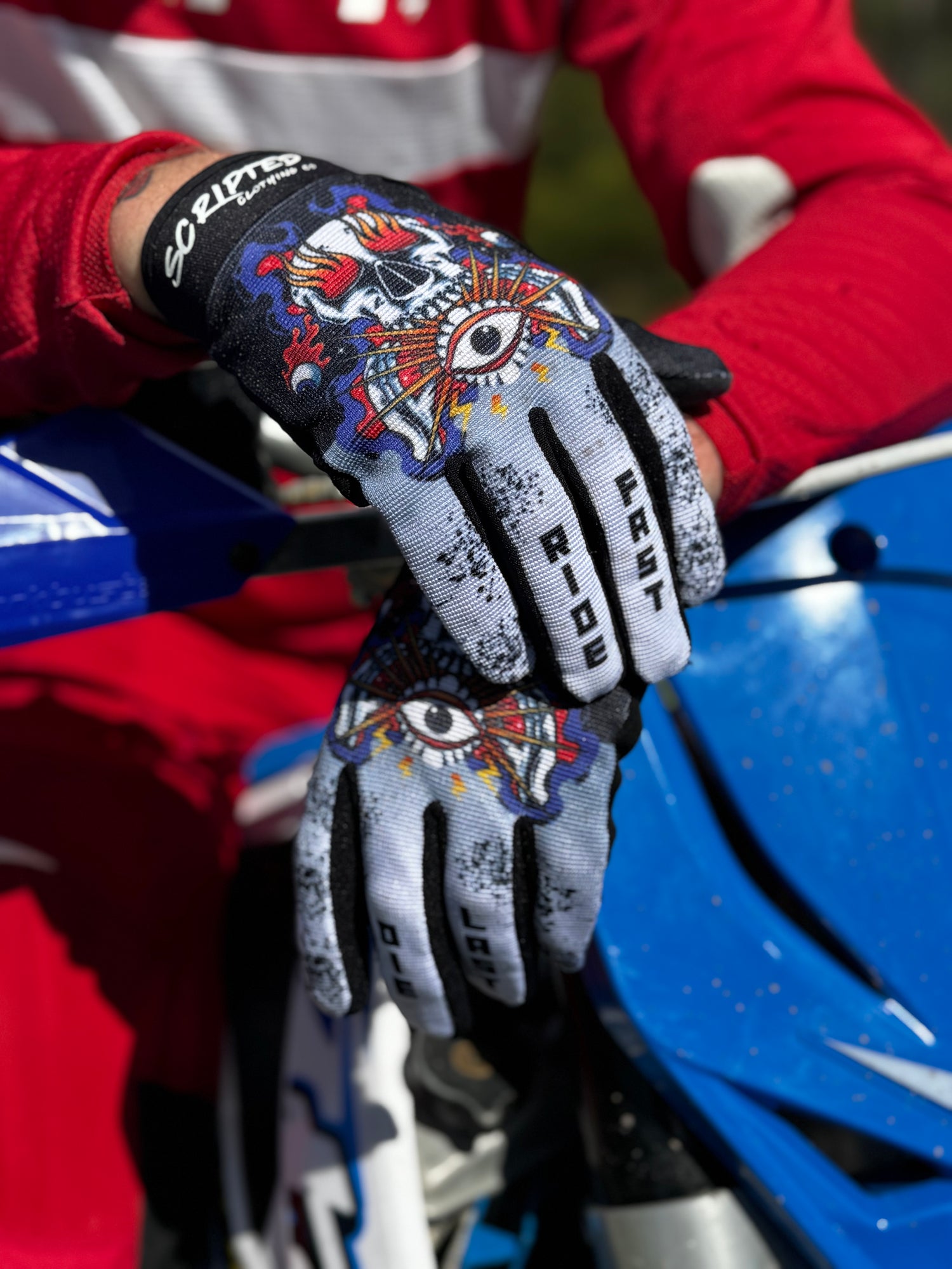 Scripted Clothing Seeing Eye MX Gloves being worn on a motorbike.
